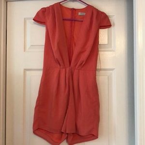Coral romper with plunging neckline